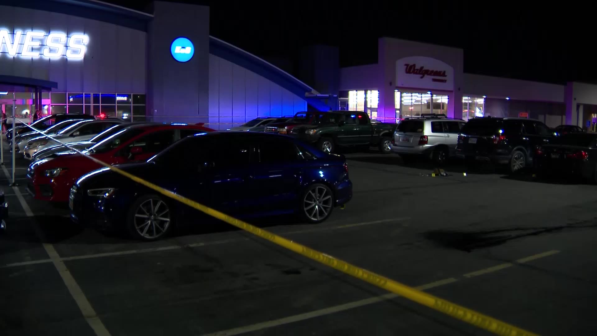Police tape is seen in the EOS Fitness parking lot in Murray after a shooting that left two people ...