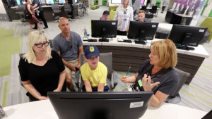 Vanessa Newton, left, Lee Newton and Brice Newton get help starting a FamilySearch account for Brice from Diane Gomm at The Church of Jesus Christ of Latter-day Saints' Family History Library in Salt Lake City on Tuesday, July 6, 2021