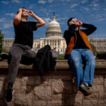 WASHINGTON, DC - APRIL 8: The U.S. Capitol Building is visible as people view the partial solar eclipse on Capitol Hill on April 8, 2024 in Washington, DC. People have traveled to areas across North America that are in the "path of totality" in order to experience the eclipse today, with the next total solar eclipse that can be seen from a large part of North America won't happen until 2044. (Photo by Andrew Harnik/Getty Images)