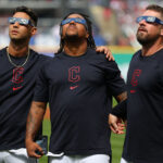 CLEVELAND, OHIO - APRIL 08: Brayan Rocchio #4, José Ramírez #11 and J.T. Maguire #84 of the Cleveland Guardians look up at the total solar eclipse before the home opener against the Chicago White Sox at Progressive Field on April 08, 2024 in Cleveland, Ohio. Cleveland is in the "path of totality" for today's total solar eclipse. (Photo by Mike Lawrie/Getty Images)