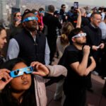 NEW YORK, NEW YORK - APRIL 08: People watch a partial solar eclipse from the Top of the Rock at Rockefeller Center on April 08, 2024 in New York City. While New York City isn't in the path of totality, it will see up to 90% of the sun covered by the moon. Around New York and in the path of totality, millions of residents and tourists are preparing for a total solar eclipse. This is the first solar eclipse to pass through North America in seven years and will be the last that will be visible from the United States until 2044. (Photo by Michael M. Santiago/Getty Images)
