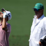 AUGUSTA, GEORGIA - APRIL 08: Eric Cole of the United States uses glasses to view the eclipse as his caddie Russell Cochran looks on during a practice round prior to the 2024 Masters Tournament at Augusta National Golf Club on April 08, 2024 in Augusta, Georgia. (Photo by Warren Little/Getty Images)