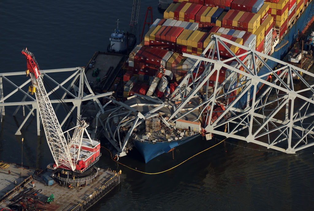 BALTIMORE, MARYLAND - APRIL 09: In an aerial view, salvage crews use a crane to remove wreckage fro...