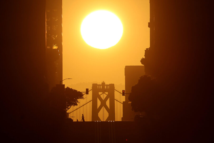 SAN FRANCISCO, CALIFORNIA - APRIL 09: The sun rises behind the San Francisco-Oakland Bay Bridge on ...