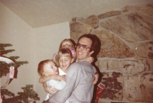 Jordan Rasmussen is pictured with his children at Christmas 1981.
