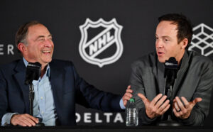 NHL Commissioner Gary Bettman laughs as Ryan Smith, co-founder and chairman of Smith Entertainment Group, speaks at a press conference at the Delta Center in Salt Lake City to announce that the NHL would be coming to Utah on Friday, April 18, 2024.