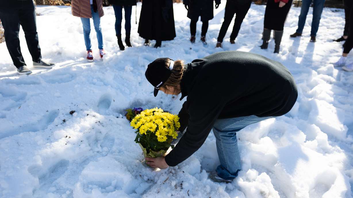 A bouquet of yellow daisies, Jordan Rasmussen’s favorite flower, is placed at his grave at Wasatc...