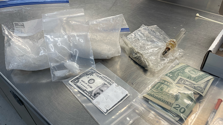 The large quantity of methamphetamine, cash, a gun, and two knives found on the suspect....
