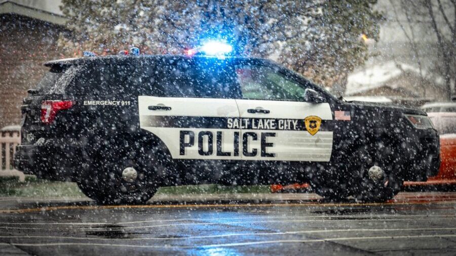 A Salt Lake City police car is parked with its lights on during a shooting investigation near 1050 ...