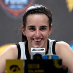 CLEVELAND, OHIO - APRIL 05: Caitlin Clark #22 of the Iowa Hawkeyes speaks with the media after beating the UConn Huskies in the NCAA Women's Basketball Tournament Final Four semifinal game at Rocket Mortgage Fieldhouse on April 05, 2024 in Cleveland, Ohio. Iowa defeated Connecticut 71-69. (Photo by Steph Chambers/Getty Images)