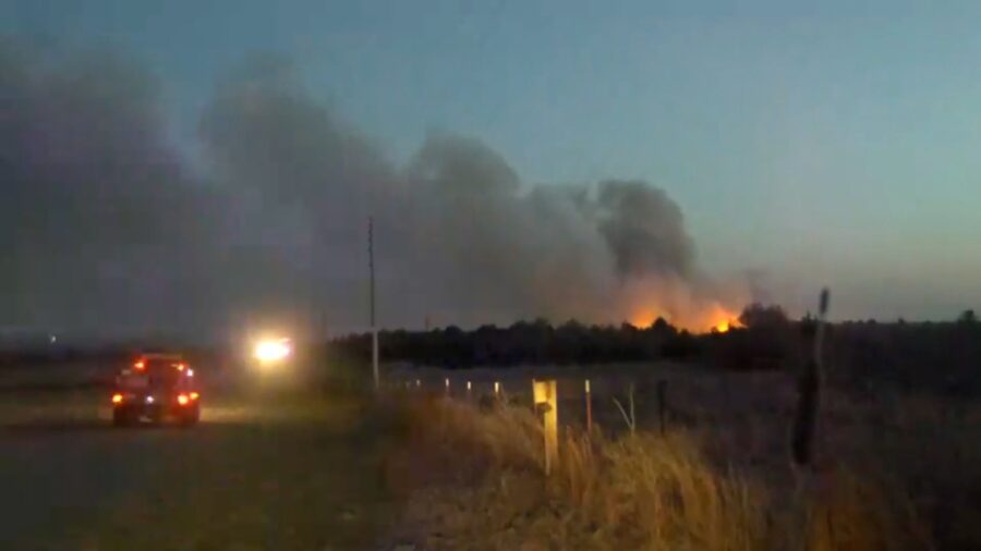 A still from a video of wildfires with heavy smoke moving through Woodward County, Oklahoma, amidst...