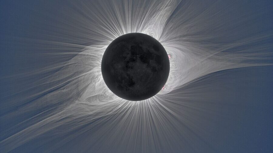 The solar corona glows in visible white light during the total solar eclipse over Mitchell, Oregon,...