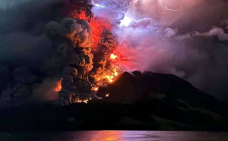 Mount Ruang spewed hot lava and ash columns into the night sky on April 17, as seen from Sitaro, No...