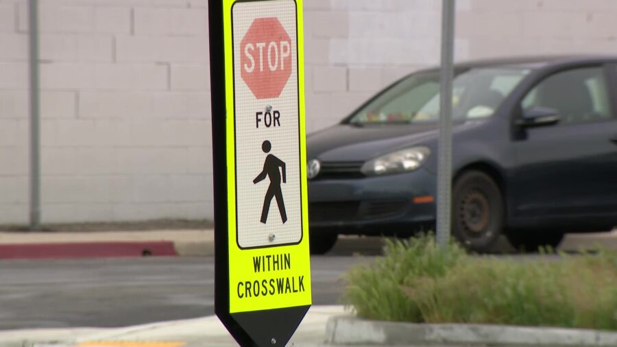 Crosswalk sign cautioning drivers on crosswalk laws...