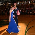 Audrey Wybrant and Buddy Jolley walk across the gym floor during the promenade at Payson High School’s prom on Saturday, April 20, 2024. (Scott G. Winterton, Deseret News) 