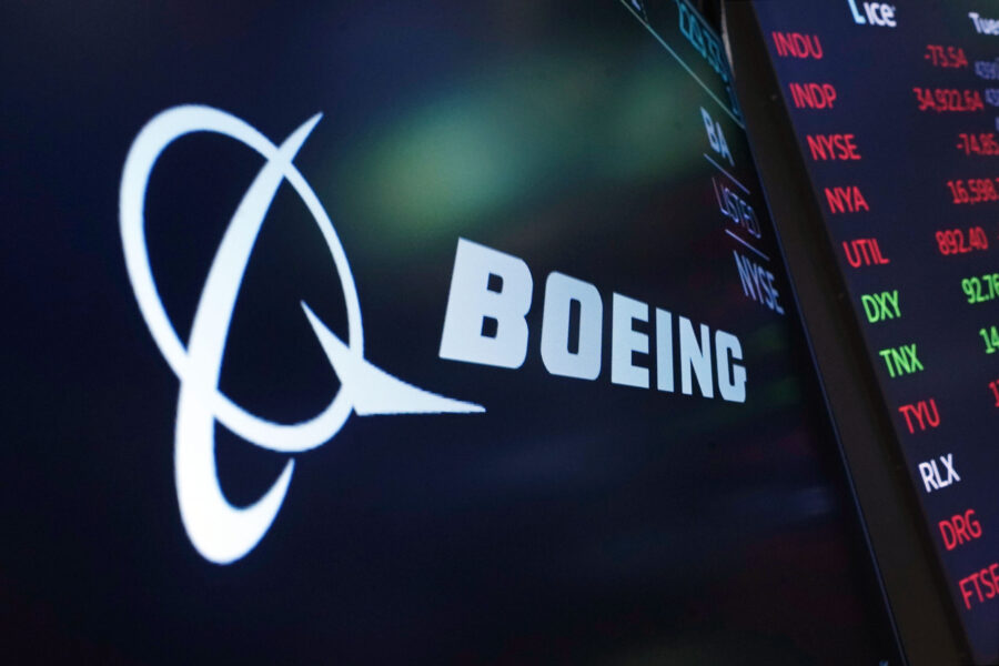 FILE - The logo for Boeing appears on a screen above a trading post on the floor of the New York St...