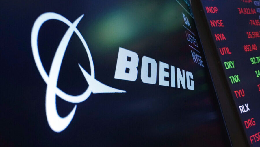 FILE - The logo for Boeing appears on a screen above a trading post on the floor of the New York St...