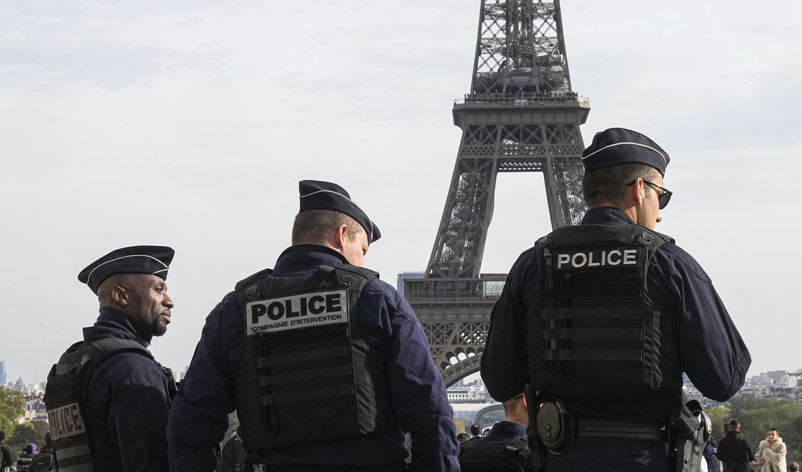 FILE - Police officers patrol the Trocadero plaza near the Eiffel Tower in Paris, Tuesday, Oct. 17,...