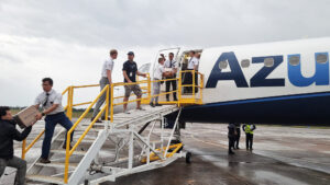Missionaries from The Church of Jesus Christ of Latter-day Saints help unload emergency supplies from an Azul airplane at a military airport in Canoas, Brazil, following severe flooding in the Rio Grande do Sul state, Brazil, May 8, 2024.