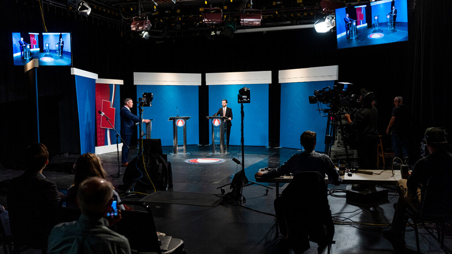 Fourth District congressional candidate Jake Hunsaker answers questions next to an empty podium dur...