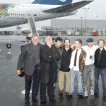 EL SEGUNDO, CA - DECEMBER 16:  (L to R) Producer Barrie M. Osborne, actors Bernard Hill, Andy Serkis, producer Mark Ordesky, actors Elijah Wood, Dominic Monaghan and Billy Boyd pose for a photograph in front of Air New Zealand's new "Lord Of The Rings" Boeing 747 at LAX's Imperial Terminal on December 16, 2002 in El Segundo, California.  The new "Frodo" imagery on the plane is part of Air New Zealand's new promotional identity as the "Airline to Middle-earth."  (Photo by Robert Mora/Getty Images)