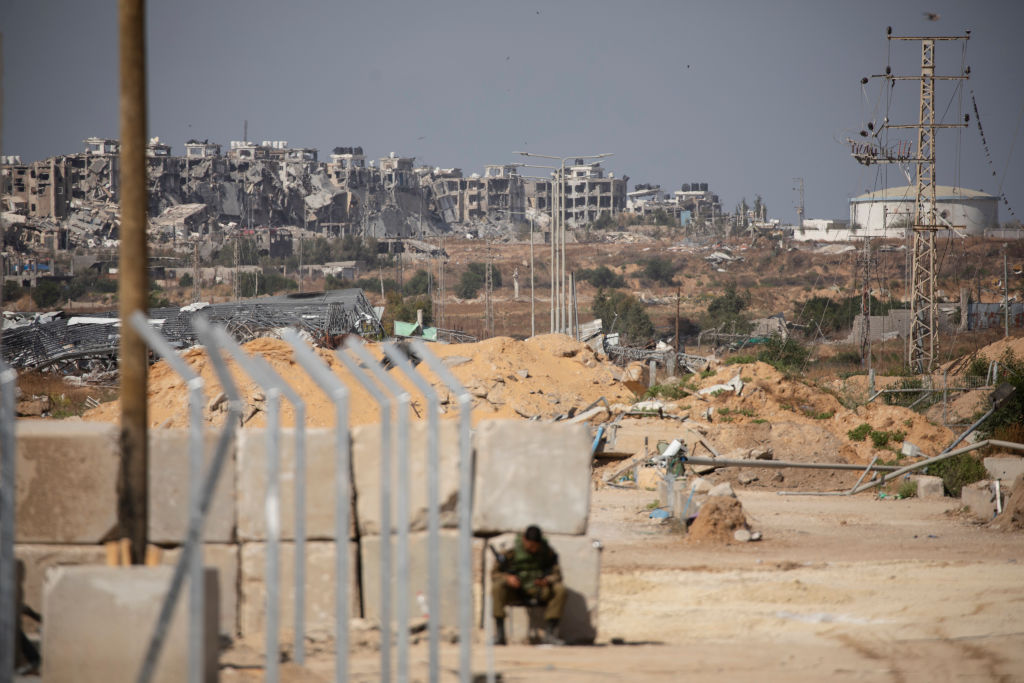 EREZ CROSSING POINT, ISRAEL - MAY 5: An Israeli soldier sits near the border with the Gaza Strip du...