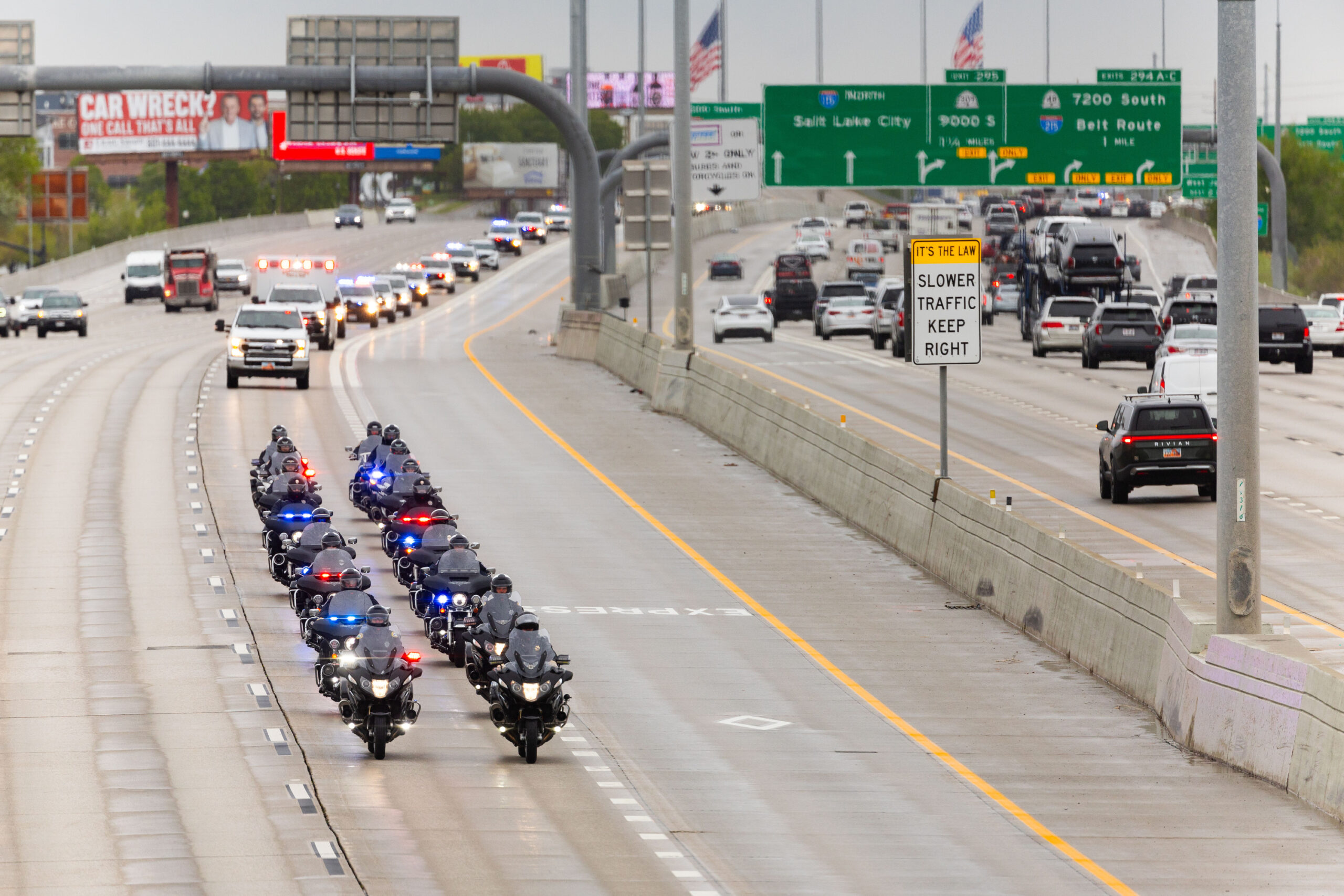 A procession with the body of a fallen Santaquin police officer drives on I-15 at 10600 South in Sa...