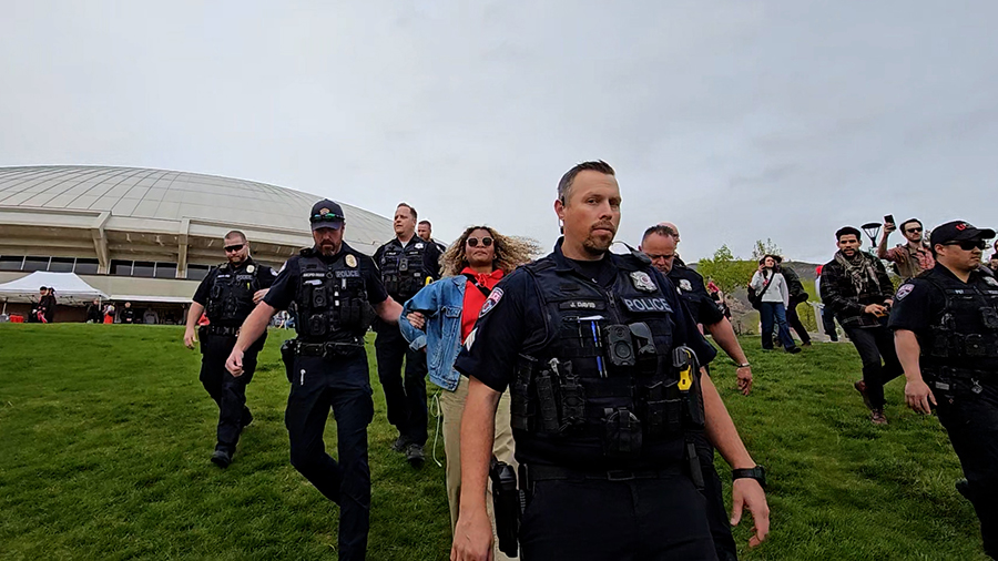 The woman demonstrator being arrested by police outside of the Huntsman Center where the University...