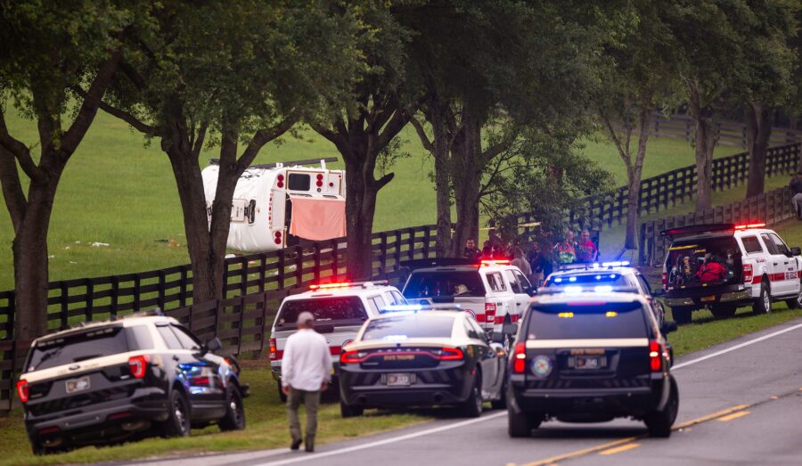 Police and firefighters work on May 14 at the scene of a crash on West Highway 40 in Marion County,...
