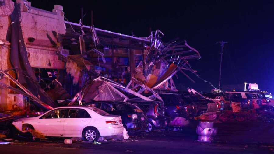 Several cars are seen heavily damaged outside the remains of a Shell gas station after a suspected ...