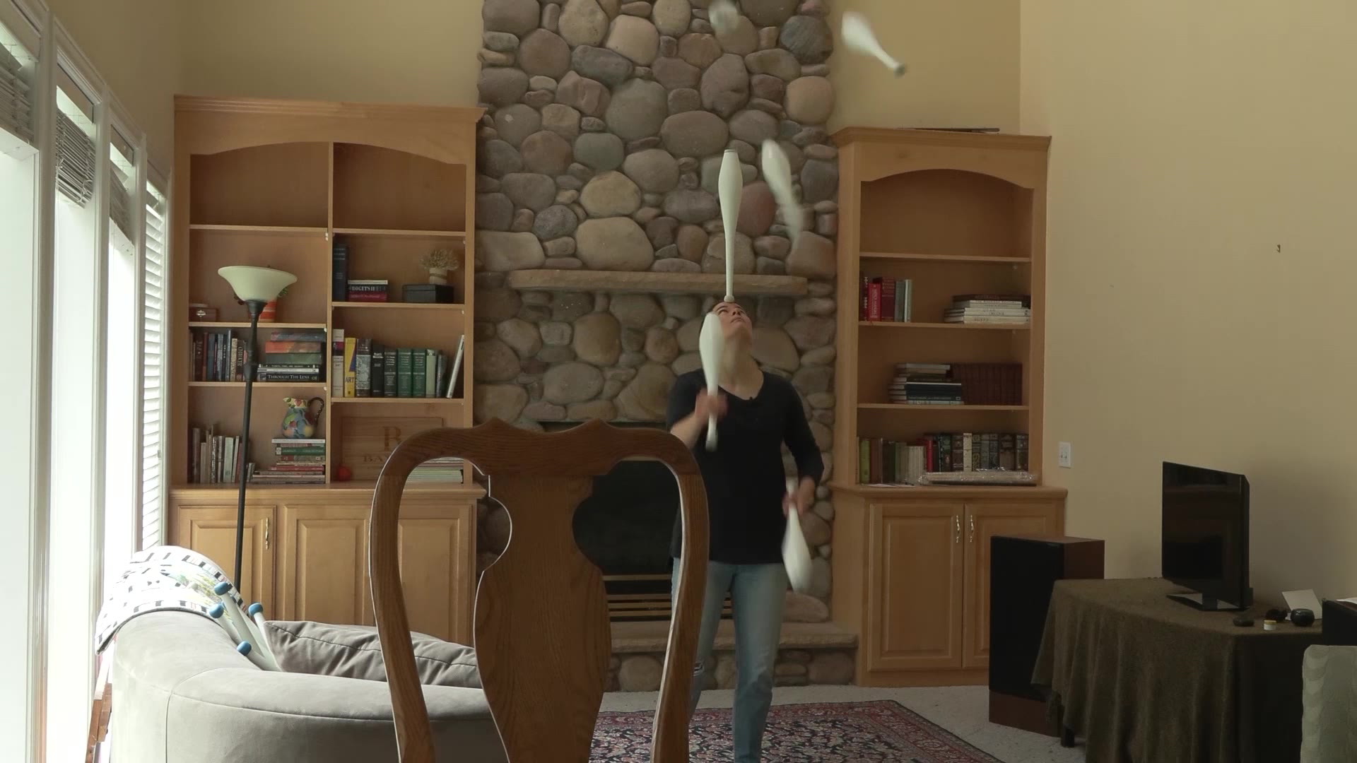 Delaney Bayles practices her juggling skills in her living room. 