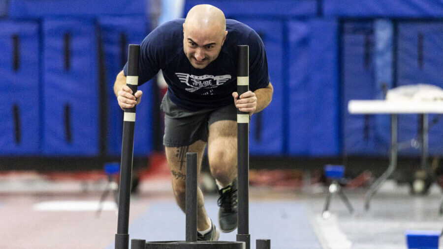 Mason Rodriques, of North Salt Lake, participates in the prowler push during a recruiting combine f...