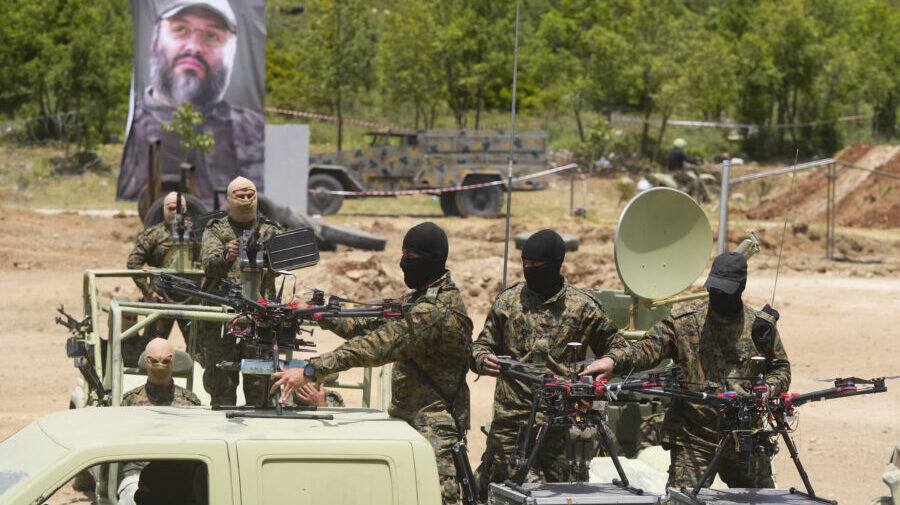 Hezbollah militants take part in a military exercise with armed drones in Aaramta village in the Je...