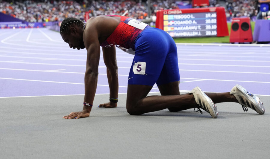 Noah Lyles, of the United States, rests on the track following the men's 200-meters final at the 20...