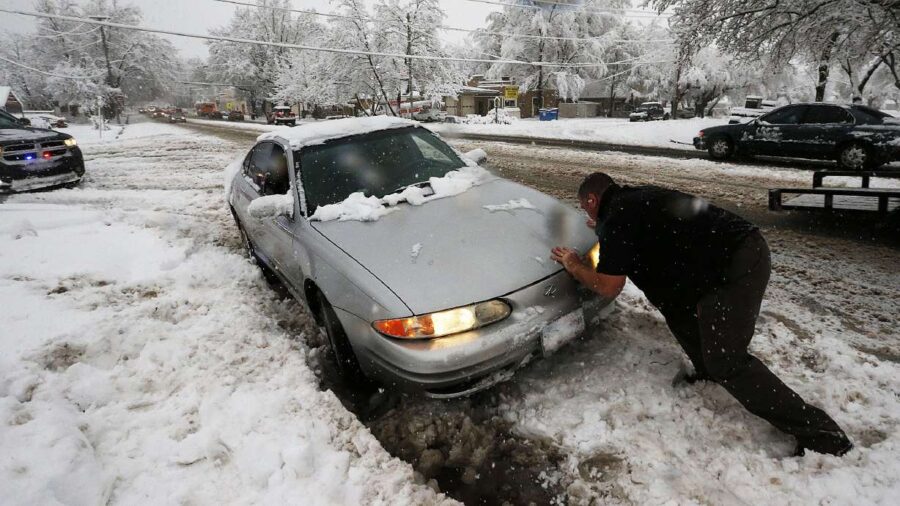 An officer helps free a car stuck on Main Street in Farmington, Dec. 14, 2015. When it comes to get...