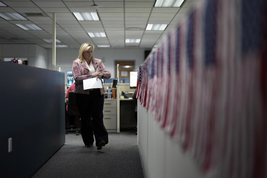 Cari-Ann Burgess, interim registrar of voters for Washoe County, Nev., walks through the office Sep...