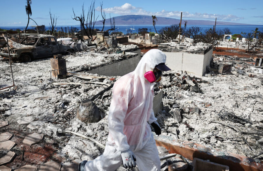 LAHAINA, HAWAII - OCTOBER 09: A volunteer from Samaritan's Purse helps a daughter search for family...