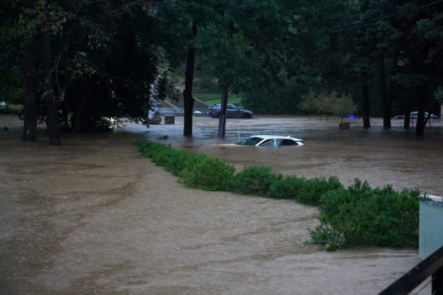 ATLANTA, GEORGIA - SEPTEMBER 27: A car is submerged in the floodwaters in the Buckhead neighborhood...