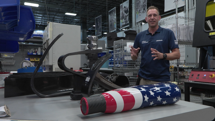 eff Waldmuller stands in front of several different designs of Ottobock prosthetics (KSL TV)...