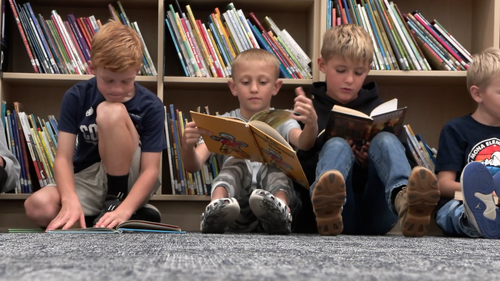 A group of 5th graders reading books inside of the new Mona Elementary school library....