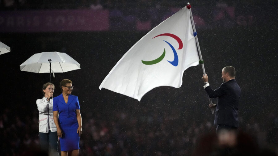 President of the International Paralympic Committee Andrew Parsons passes the Paralympic flag to Ma...