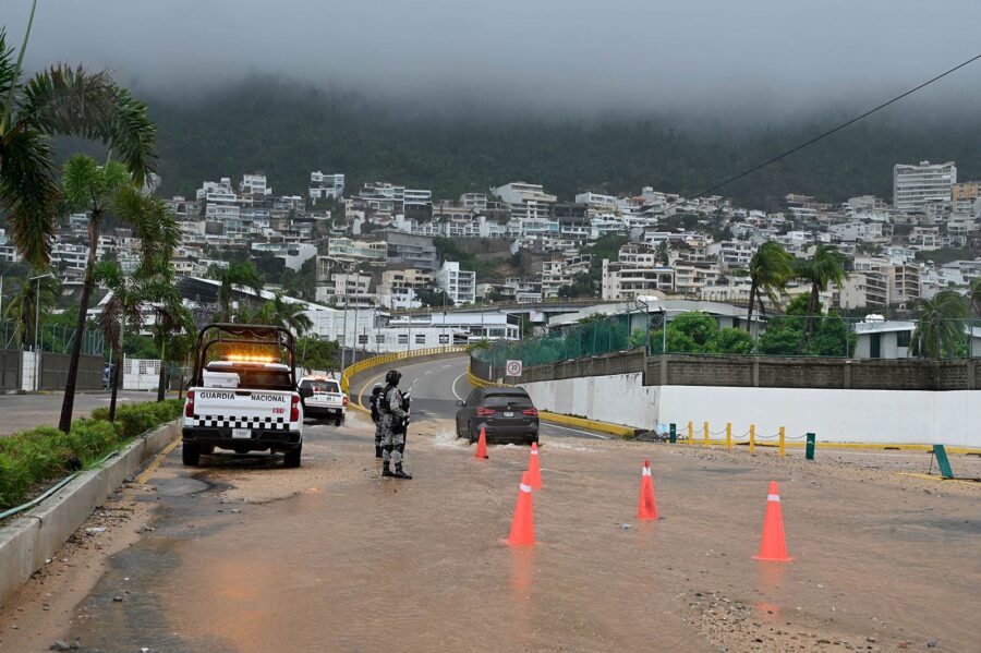 Security forces stands guard on a flooded road after Hurricane John in Acapulco, Mexico on Septembe...