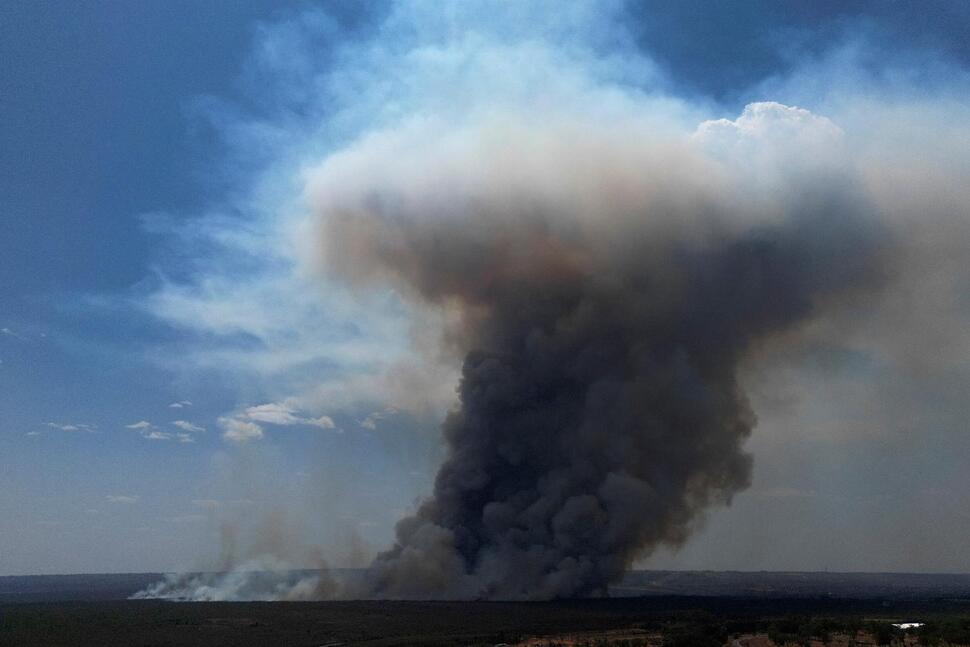 Smoke rises from fire in the environmentally protected area of Brasilia National Park during the dr...