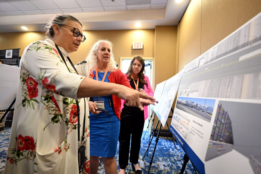 Julie Olson, an artist who lives near the project area, looks over the displays with Laura Haddad, ...