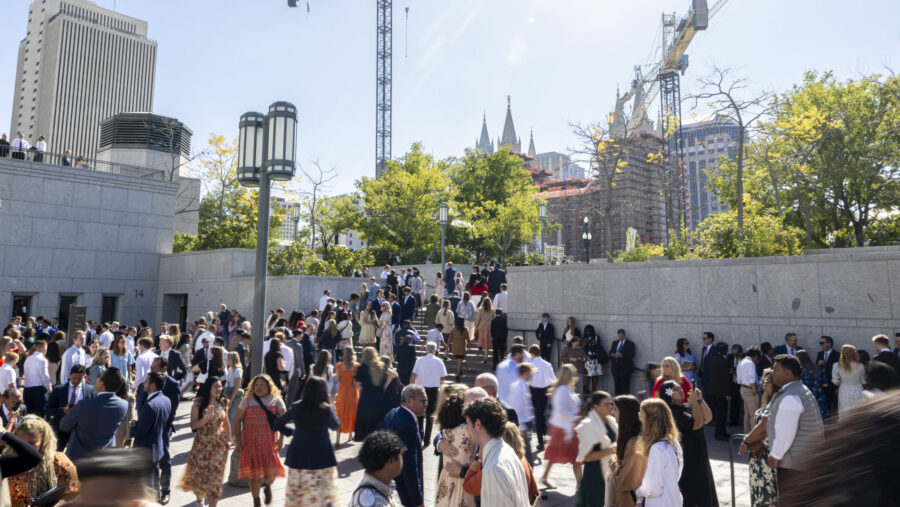 Conferencegoers exit the Conference Center after the morning session of the 194th Semiannual Genera...