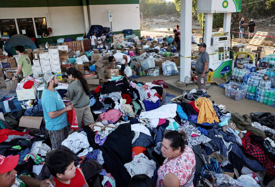 SWANNANOA, NORTH CAROLINA - OCTOBER 07: People collect donated items at a shuttered gas station alo...