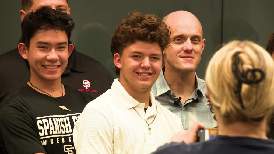 PJ Merrill (left), Treven Elquist (center) stand with Farris Child (left), the man who's life they ...