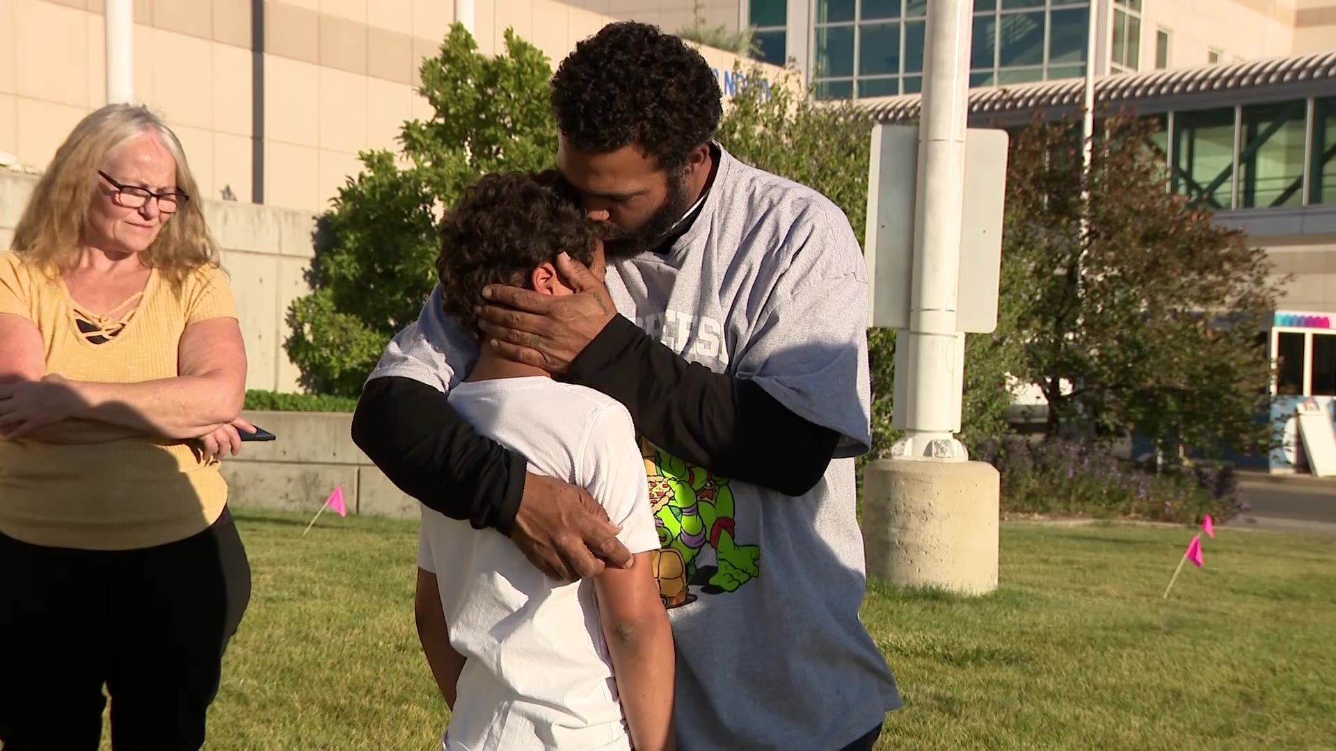 Fred with his eldest son Freddie in front of the hospital.