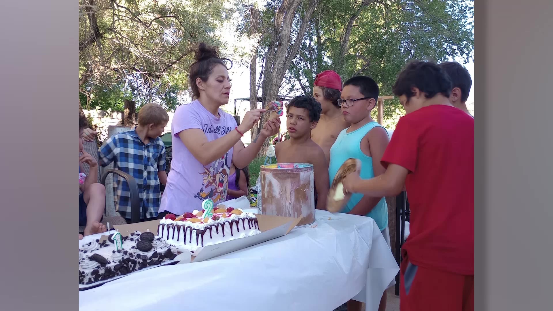 Norma helps children at a birthday party by serving them ice cream. 