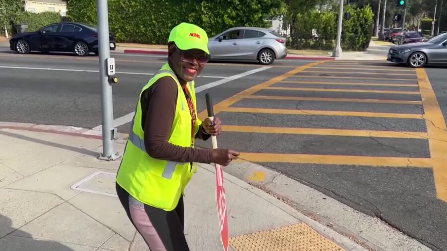 Betty Miller in her morning duties, helping kids get across the street, moms get rides when they ne...